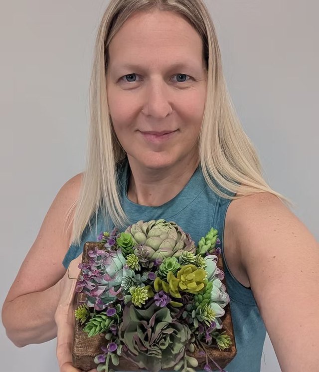 Moriah Baker holding a succulent arrangement